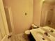 Small bathroom with a toilet, sink, and vanity on a faux marble floor and shower in the background at 4842 Hairston Park Sq, Stone Mountain, GA 30083