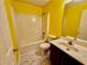 Bright bathroom featuring a shower-tub combo and single sink vanity with marble-look vinyl flooring at 4842 Hairston Park Sq, Stone Mountain, GA 30083