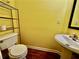 Compact yellow bathroom features a pedestal sink and matching decor at 4842 Hairston Park Sq, Stone Mountain, GA 30083