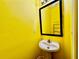 Bright half bath with a black framed mirror and yellow walls at 4842 Hairston Park Sq, Stone Mountain, GA 30083