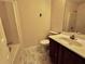 Small bathroom with a toilet, sink, vanity, shower, and faux marble floors at 4842 Hairston Park Sq, Stone Mountain, GA 30083