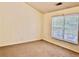 Carpeted bedroom featuring a bright window with blinds, neutral paint, and base trim at 4842 Hairston Park Sq, Stone Mountain, GA 30083