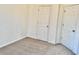 This bedroom features carpet floors, neutral paint, and two doors to closets or other rooms at 4842 Hairston Park Sq, Stone Mountain, GA 30083