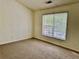 Carpeted bedroom featuring a bright window with blinds, neutral paint and base trim at 4842 Hairston Park Sq, Stone Mountain, GA 30083