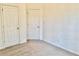 This bedroom features carpet floors, neutral paint, and two doors to closets or other rooms at 4842 Hairston Park Sq, Stone Mountain, GA 30083