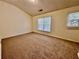 This bedroom features carpet floors, neutral paint, and double-paned windows to let the sunshine in at 4842 Hairston Park Sq, Stone Mountain, GA 30083