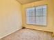Cozy carpeted bedroom with a bright window and neutral walls provides a serene living space at 4842 Hairston Park Sq, Stone Mountain, GA 30083