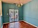 Cozy dining room with hardwood floors, a sliding glass door to the backyard, and a chandelier at 4842 Hairston Park Sq, Stone Mountain, GA 30083