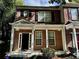 Charming brick townhouse with a welcoming front porch and classic architectural details at 4842 Hairston Park Sq, Stone Mountain, GA 30083