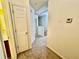 Hallway with neutral paint, carpet floor and doors to several rooms at 4842 Hairston Park Sq, Stone Mountain, GA 30083