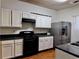 Clean kitchen offering white cabinets, black appliances and steel refrigerator at 4842 Hairston Park Sq, Stone Mountain, GA 30083