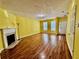 Open-concept living room with hardwood floors, fireplace, and ample space for entertaining at 4842 Hairston Park Sq, Stone Mountain, GA 30083