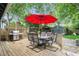 Enjoy outdoor living on this spacious back deck with a grill and dining area shaded by a red umbrella at 541 Greenwood Ne Ave, Atlanta, GA 30308