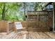 Cozy back deck featuring wooden privacy screens, a comfortable lounge chair, and built-in planter boxes at 541 Greenwood Ne Ave, Atlanta, GA 30308