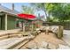 Inviting backyard with a wooden deck, patio seating, fire pit, and lush landscaping for outdoor enjoyment at 541 Greenwood Ne Ave, Atlanta, GA 30308