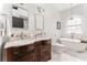 Bright bathroom with dual vanities, soaking tub, glass-enclosed shower, and elegant finishes at 541 Greenwood Ne Ave, Atlanta, GA 30308