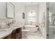 Bright bathroom with marble floors, dual vanities, a stand-alone tub, and glass-enclosed shower at 541 Greenwood Ne Ave, Atlanta, GA 30308