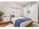 Bright bedroom with a queen bed, white shiplap walls, and custom-built wardrobe at 541 Greenwood Ne Ave, Atlanta, GA 30308