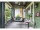 Relaxing front porch with swing, ceiling fan, and vintage-style outdoor lighting at 541 Greenwood Ne Ave, Atlanta, GA 30308