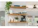 Kitchen features open shelving, modern appliances, a coffee maker, and backyard view at 541 Greenwood Ne Ave, Atlanta, GA 30308