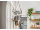 Bright kitchen featuring a hanging pot rack, white shutters, and open shelving with decorative plants at 541 Greenwood Ne Ave, Atlanta, GA 30308