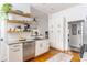Well-lit kitchen featuring white cabinetry, granite countertops, stainless steel appliances, and open shelving at 541 Greenwood Ne Ave, Atlanta, GA 30308