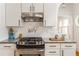 Modern kitchen with stainless steel range, granite countertops and white cabinets at 541 Greenwood Ne Ave, Atlanta, GA 30308