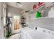 Functional laundry room with washer, dryer, storage shelves, and access to the outdoors at 541 Greenwood Ne Ave, Atlanta, GA 30308