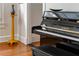 Close-up of a black Yamaha piano with a bench, enhancing the home's musical ambiance at 541 Greenwood Ne Ave, Atlanta, GA 30308
