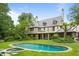 Spacious backyard with manicured lawn, pool, hot tub, and view of the home's rear exterior at 675 W Paces Ferry Nw Rd # 11, Atlanta, GA 30327