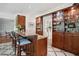 Beautiful wet bar features custom cabinetry with glass shelves and a marble countertop bar at 675 W Paces Ferry Nw Rd # 11, Atlanta, GA 30327