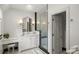 Clean bathroom design with white cabinetry, marble countertops, patterned tile, and glass enclosed shower at 675 W Paces Ferry Nw Rd # 11, Atlanta, GA 30327