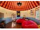 Fun bedroom featuring red beanbag chairs, unique rounded walls, wood floors, and a decorative domed ceiling at 675 W Paces Ferry Nw Rd # 11, Atlanta, GA 30327