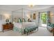 Bright bedroom with a canopy bed, balcony access, and coordinated decor at 675 W Paces Ferry Nw Rd # 11, Atlanta, GA 30327