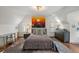 Spacious bedroom with hardwood floors, a modern light fixture, and a large piece of art at 675 W Paces Ferry Nw Rd # 11, Atlanta, GA 30327
