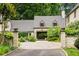 Grand home with a circular driveway, lush landscaping, and a porte cochere at 675 W Paces Ferry Nw Rd # 11, Atlanta, GA 30327
