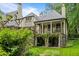 Elegant home with a stone foundation, covered balconies, and lush greenery at 675 W Paces Ferry Nw Rd # 11, Atlanta, GA 30327
