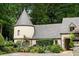 Charming home with a turret, colorful landscaping, and a circular driveway at 675 W Paces Ferry Nw Rd # 11, Atlanta, GA 30327