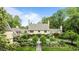Stately home boasts manicured landscaping, blooming flowers, and mature trees for ultimate curb appeal at 675 W Paces Ferry Nw Rd # 11, Atlanta, GA 30327
