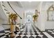 Elegant foyer with black and white tile flooring, curved staircase, and ornate decor at 675 W Paces Ferry Nw Rd # 11, Atlanta, GA 30327
