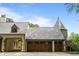 Attached three-car garage featuring beautiful wood doors, and a porte cochere at 675 W Paces Ferry Nw Rd # 11, Atlanta, GA 30327
