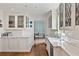 Classic kitchen with white cabinets, marble countertops, and a cozy dining area beyond at 675 W Paces Ferry Nw Rd # 11, Atlanta, GA 30327