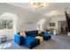 Attic living room featuring a comfy blue couch, sloped ceilings, and bright windows at 675 W Paces Ferry Nw Rd # 11, Atlanta, GA 30327