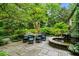 Outdoor dining area on a stone patio with seating for six next to a water feature at 675 W Paces Ferry Nw Rd # 11, Atlanta, GA 30327