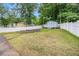 Spacious backyard with a privacy fence, shed, and lush green space, perfect for outdoor activities at 7845 Chase Woods Dr, Jonesboro, GA 30236