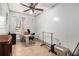 Bright bedroom featuring tiled floors, a ceiling fan and ample workspace with a large window at 7845 Chase Woods Dr, Jonesboro, GA 30236