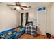 A cute bedroom with a bed shaped like a race car and a ceiling fan at 7845 Chase Woods Dr, Jonesboro, GA 30236