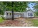 Inviting one-story home boasts a covered porch and well-maintained landscaping in a serene, wooded neighborhood at 7845 Chase Woods Dr, Jonesboro, GA 30236