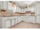 Well-lit kitchen with white cabinets, neutral backsplash, and modern appliances for all your cooking needs at 7845 Chase Woods Dr, Jonesboro, GA 30236