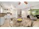 Open concept kitchen with white cabinetry, granite countertops, and a spacious dining area at 7845 Chase Woods Dr, Jonesboro, GA 30236